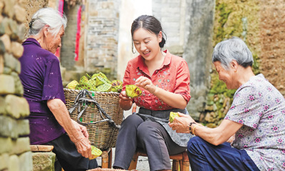 Shen Zhidan (tengah) sedang mengopek benih teratai dengan penduduk kampung di bandar Wuyishan, Provinsi Fujian di tenggara China. (Foto fail)