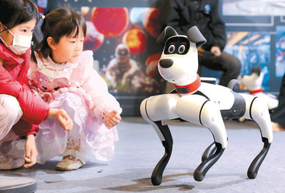 Kanak-kanak sedang berinteraksi dengan anjing robotik semasa Pameran Robot Pintar AI Huan Meng 2025 di bandar Fuzhou, Provinsi Fujian, di tenggara China pada 8 Mac 2025. (Foto/Wang Wangwang)