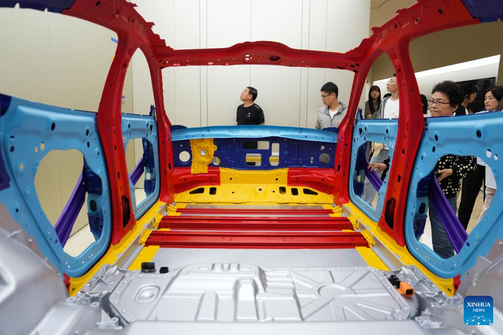 Pengunjung mempelajari mengenai badan kereta di kilang automobil Xiaomi di Beijing, pada 16 Jun 2025. (Xinhua/Zheng Huansong)