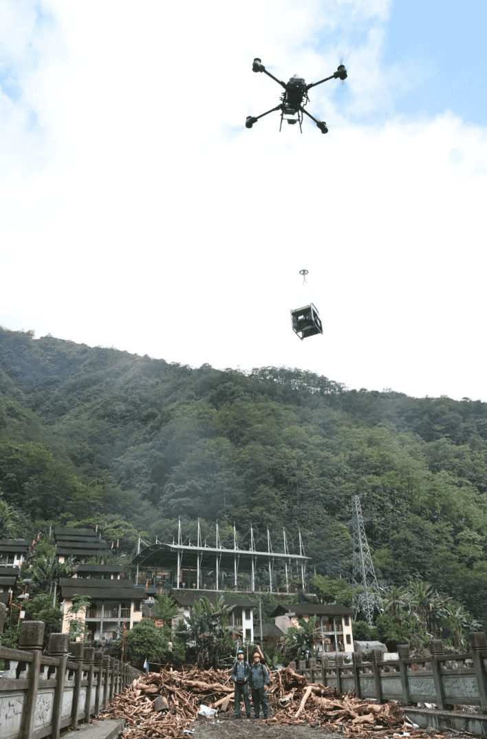 Para petugas dari sebuah syarikat subsidiari milik China Southern Power Grid mengoperasikan dron untuk menghantar sebuah generator ke tebing sungai yang bertentangan Sungai Dulong pada 5 Jun. (Foto oleh Lai Zengpeng)